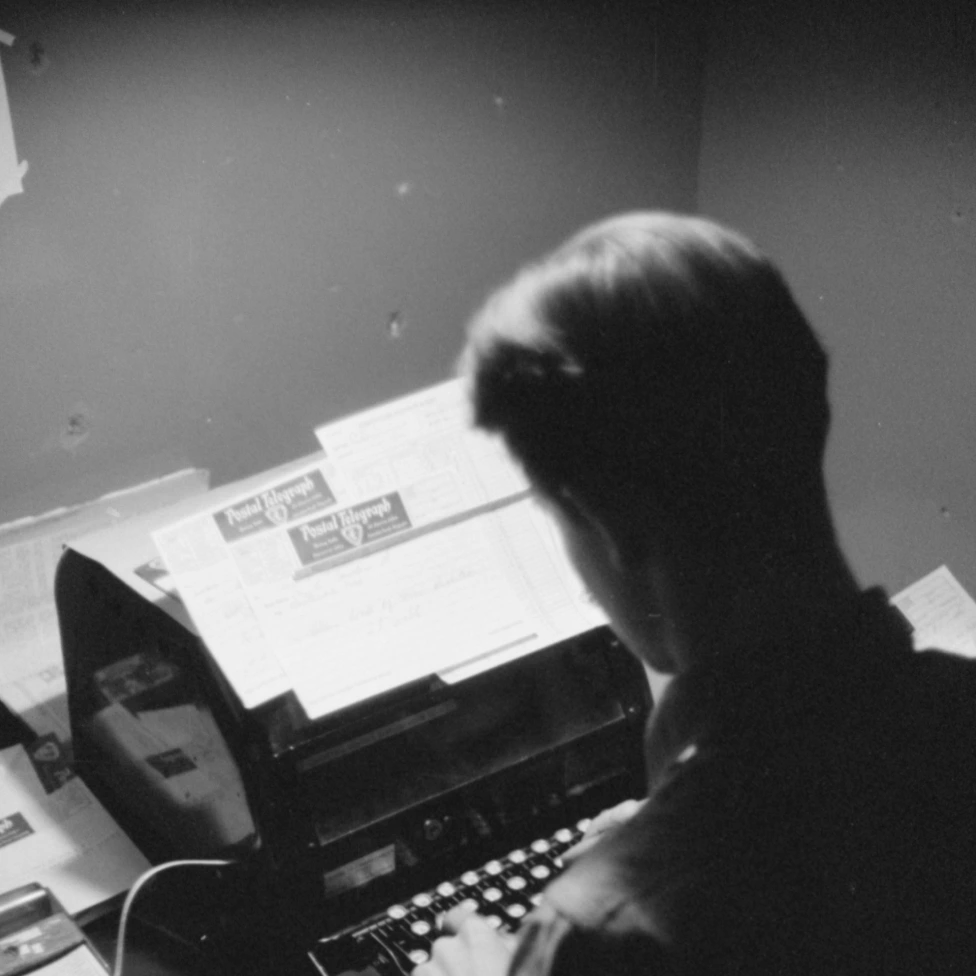 About Picture of a person typing on a typewriter.